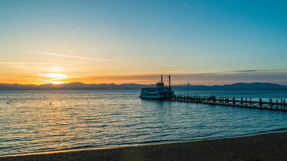 The M.S. Dixie II at the end of the long Zephyr Cove pier at sunset