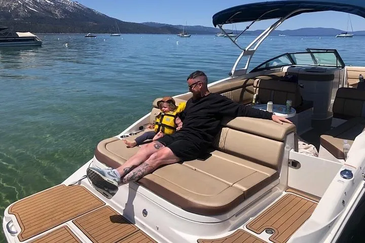 A guest relaxing on the cream seats of a private motor yacht on Lake Tahoe