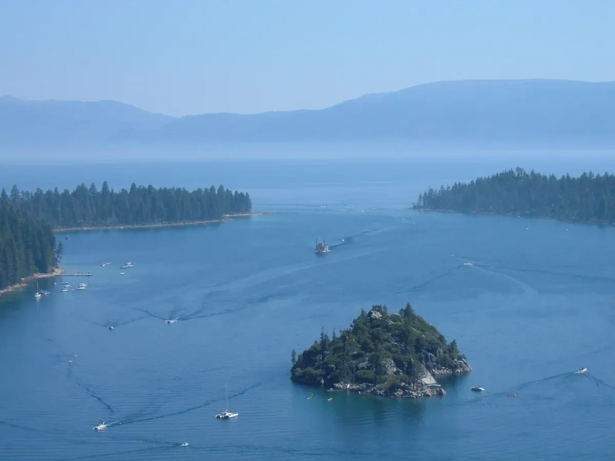 A paddle-wheeler cruising past Fannette Island in Emerald Bay seen from the Highway 89 overlook