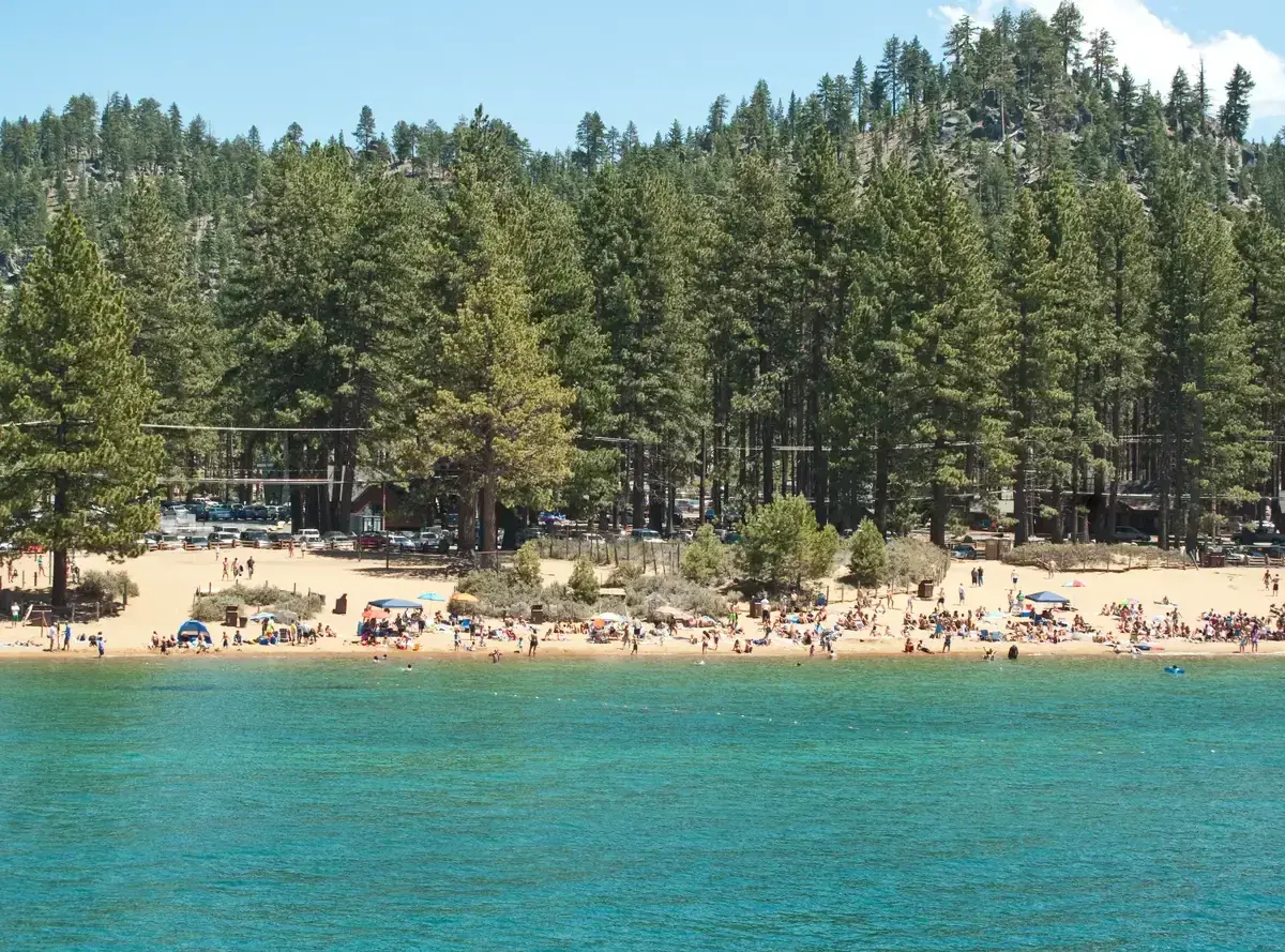 The sandy beach and pine forest at Zephyr Cove on the Nevada shore of Lake Tahoe
